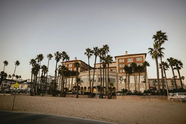 Illustrative coastal hotel exterior with palm trees