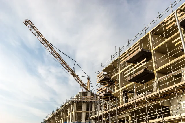 Illustrative development project with a tower crane and scaffolding