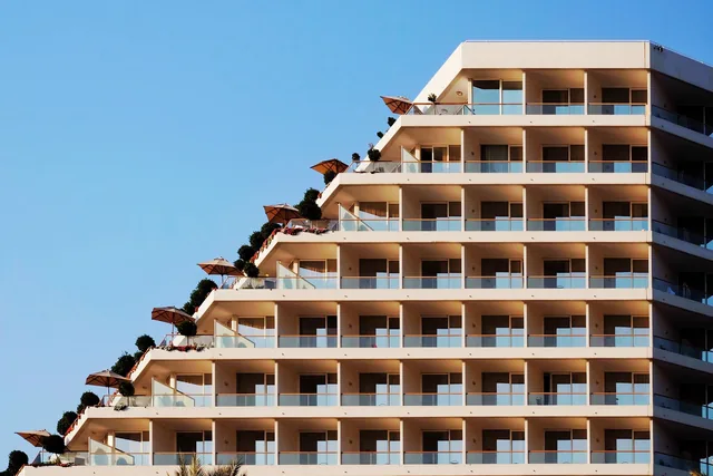Illustrative resort hotel exterior with stepped terraces and balconies